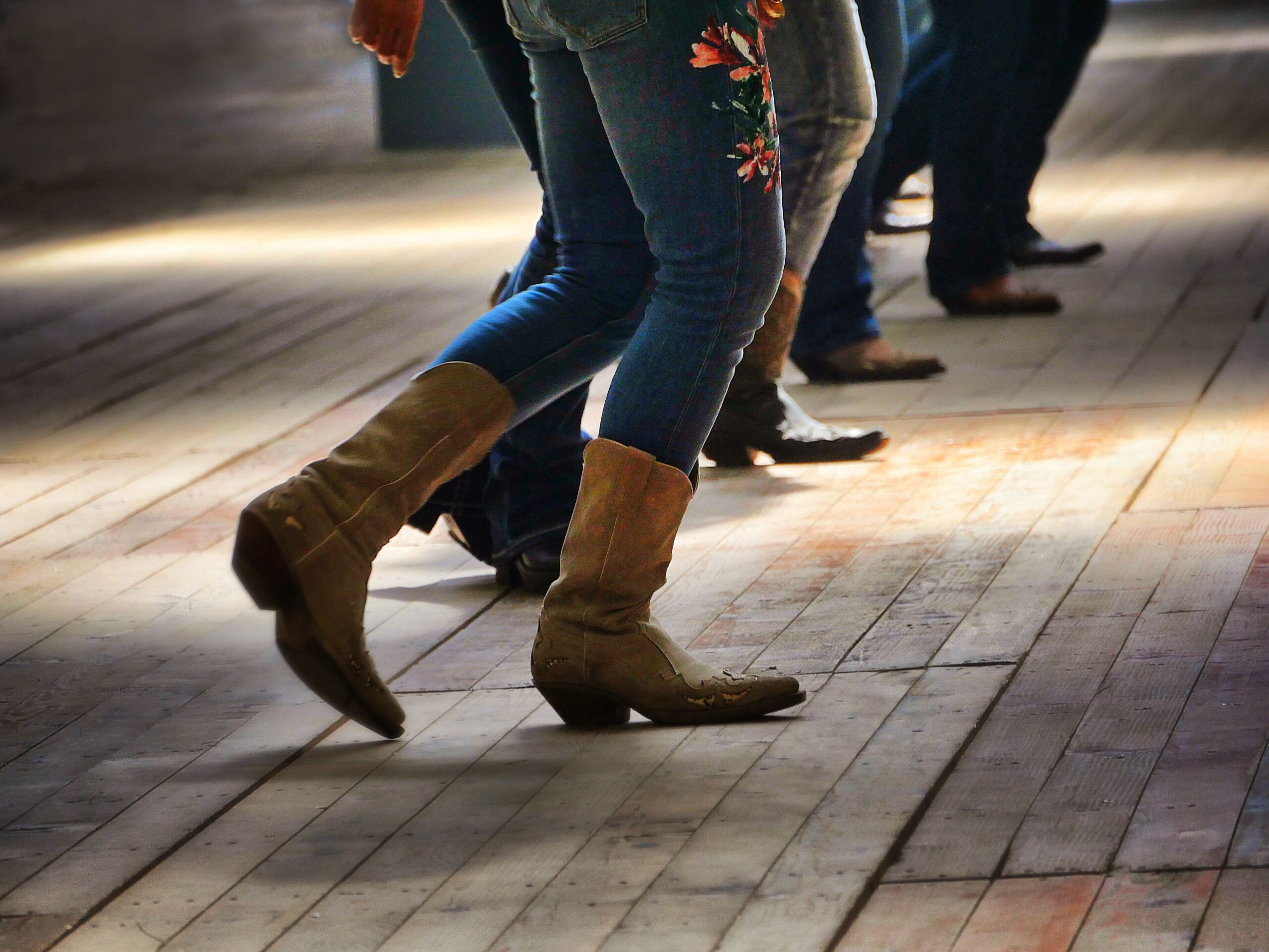 A closeup shot of the legs of traditional western folk dancing under the music
